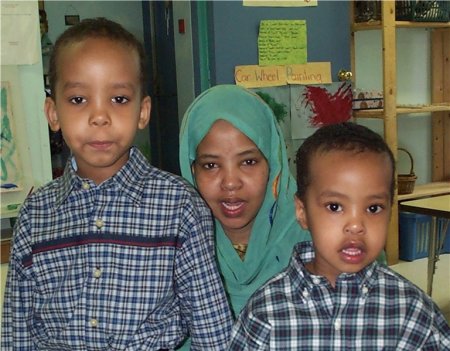 Three children posing for a photograph.
