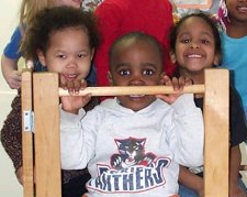Three children posing and smiling 