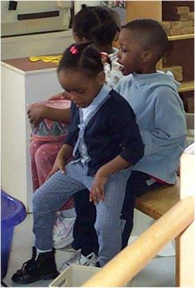 A child sits on another lap